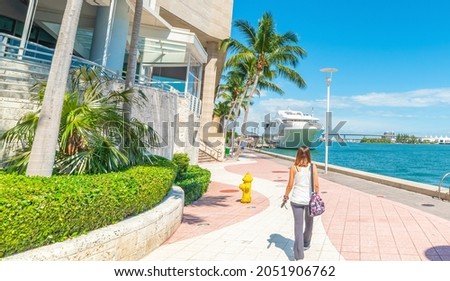 Girl walking in beautiful Miami River walk. Florida, USA