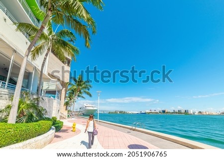Girl walking in beautiful Miami River walk on a sunny day. Florida, USA