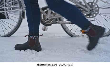 Girl Walking With City Bike Through Fresh Thick Snow after Unexpected Intense Snowfall Blizzard Snowfall on Beautiful Cold Winter Day