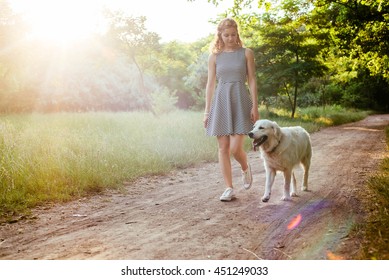 Girl Walking Dog In Park