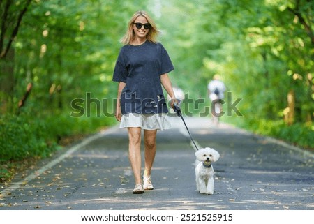 Similar – Image, Stock Photo Woman Walking Dog in Park