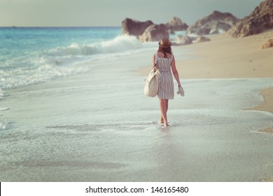 A girl walking on a beach 