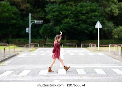 Girl Walking On A Crosswalk