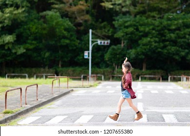 Girl Walking On A Crosswalk