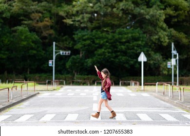 Girl Walking On A Crosswalk