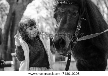 girl walking in the Park with grandma . rides on a pony