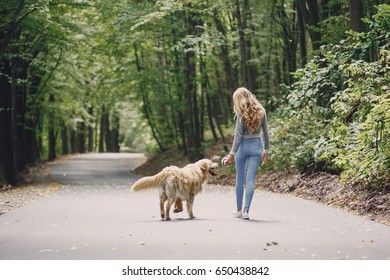 girl walking in the park with his dog girl playing with a dog at the beach and in the park