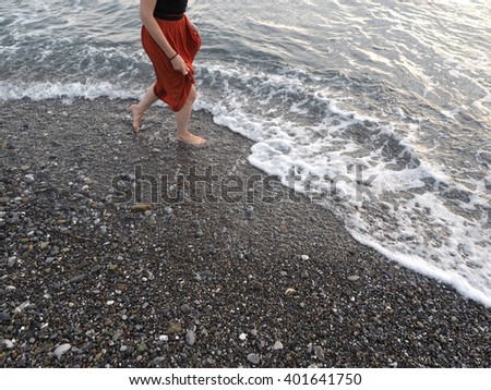 girl walking at the shore