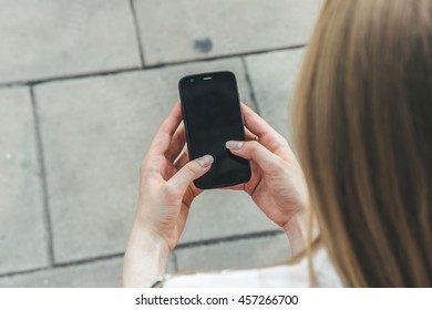 Girl Walking And Texting On The Smart Phone In The Street.