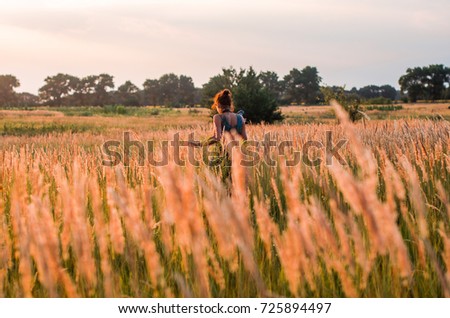 Similar – Woman alone in a field of wheat