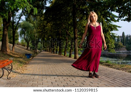 
The girl walks along the path along the canal
