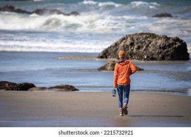 Girl Walks along the rocky shore of the oregon coast near Bandon 
