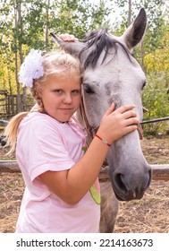 A Girl Walks With A Horse On A Warm Summer Day. 