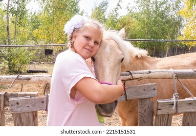 A Girl Walks With A Horse On A Warm Summer Day. 