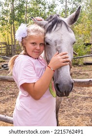 A Girl Walks With A Horse On A Warm Summer Day. 