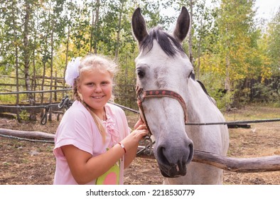 A Girl Walks With A Horse On A Warm Summer Day. 