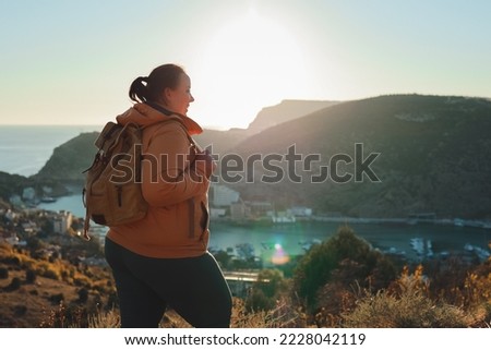 
The girl walks in the mountains and admires the beautiful views.