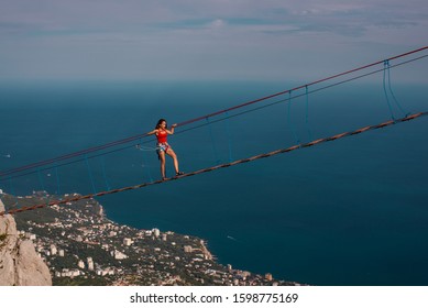 
girl walks on a suspension bridge