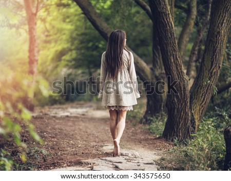 Girl walks in the park.