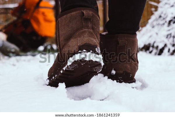 girl walks in\
the snow in boots, sole\
close-up