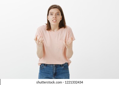 Girl Wants To Grab Boyfriend On Neck And Choke Him, Being Pissed Off. Woman Being Outraged, Gesturing With Hands And Grimacing, Being Annoyed And Fed Up While Arguing With Dumb Person