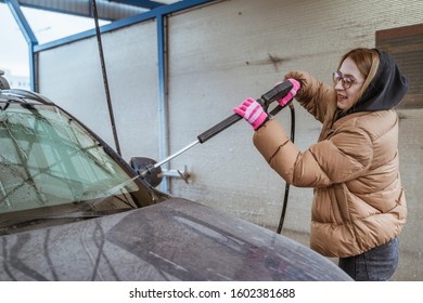 The Girl In Warm Clothes Wash Car Outdoot In Winter Cold Time