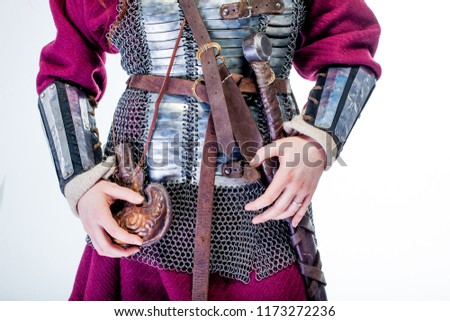 girl warrior in chain mail and with sword in hand, woman viking in historical battle armor, Middle Ages
