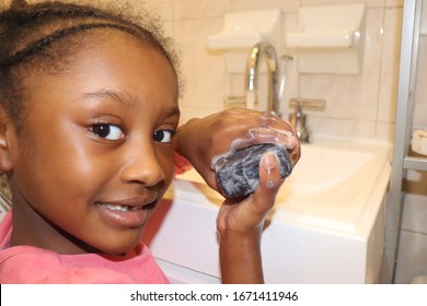 Girl Washing Hands With Black Soap