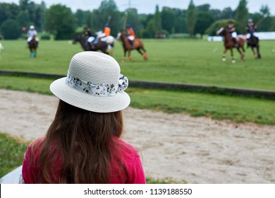 a girl is watching a polo tournament - Powered by Shutterstock