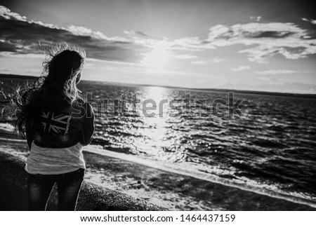 Similar – Image, Stock Photo Young woman with pipe backlit by the sea in the midnight sun