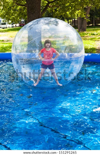 girl in water ball in\
open swimming pool