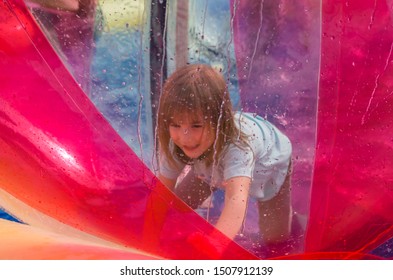 girl in water balloons zorb on the water