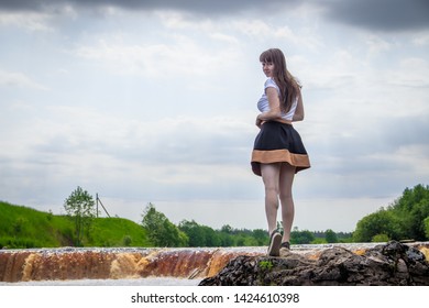 The girl at the waterfall. Young beautiful girl on a little waterfall. Little waterfall. - Shutterstock ID 1424610398
