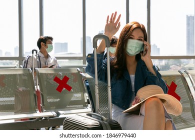 Girl Waves Her Hand On Arrival. Woman Sitting In Hall Along The Window Out Of Gate Saying Hi To Her Friends Cheerful.