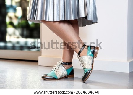 a girl  wear fancy leather shoes