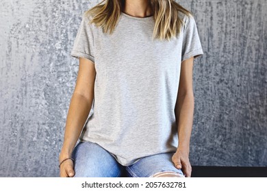 Girl Wearing Blank Gray T Shirt And Denim Posing Against Gray Wall, Blank Mockup For T-shirt Print Shop