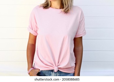 Girl wearing blank soft pink t shirt  posing against white wooden wall, blank mockup for t-shirt print shop - Shutterstock ID 2058088685