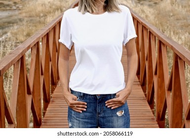 Girl Wearing Blank White T Shirt And Denim On Wooden Road , Blank Fall , Halloween Mockup For T-shirt Printing Store Mock Up