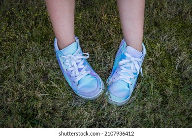 Girl Wearing Blue And Purple Tie-dye High-top Tennis Shoes In The Grass