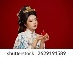 Girl wearing Chinese Ming Dynasty Hanfu costume against a red background