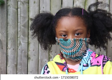 Girl Wearing Cloth Facemask Outside Wooden Fence Background