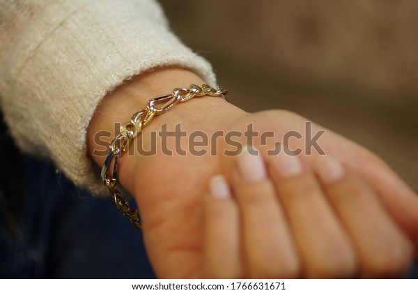 girl wearing a diamond\
bracelet