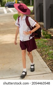 A Girl Wearing Maroon And White School Uniform Walking To School Alone. School Students Return To Classrooms After COVID-19 Outbreak In Australia