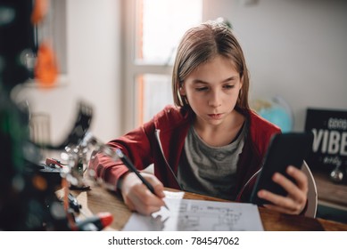 Girl Wearing Red Hoodie Using Smart Phone To Check Electrical Schematic At Home