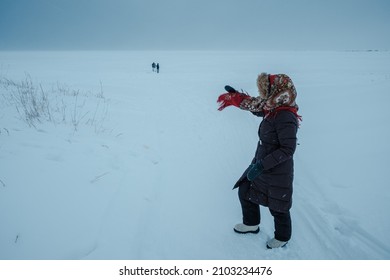 A Girl Wearing A Russian Folk Shawl Stands On The Shore Of The White Sea In Winter.