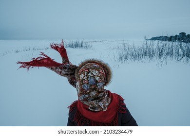 A Girl Wearing A Russian Folk Shawl Stands On The Shore Of The White Sea In Winter.