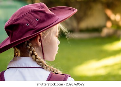 A Girl Wearing School Uniform, White Shirt, Maroon Backpack And Maroon Hat Back To School. Return To Classrooms After COVID-19 Outbreak In Australia