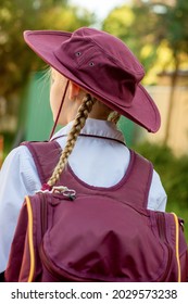 A Girl Wearing School Uniform, White Shirt, Maroon Backpack And Maroon Hat Back To School. Return To Classrooms After COVID-19 Outbreak In Australia