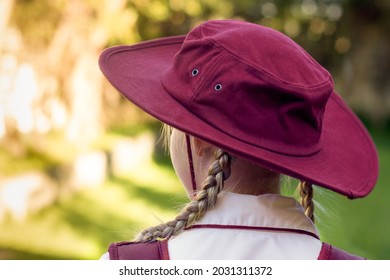 A Girl Wearing School Uniform, White Shirt, Maroon Backpack And Maroon Hat Back To School. Return To Classrooms After COVID-19 Outbreak In Australia