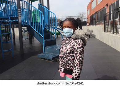 Girl Wearing Surgical Mask On City Playground